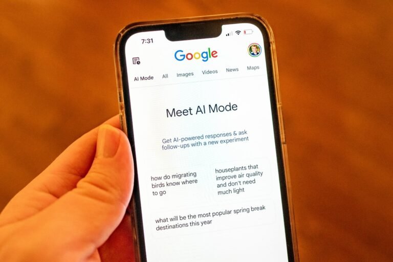 A person holding an iPhone and using Google AI Mode
