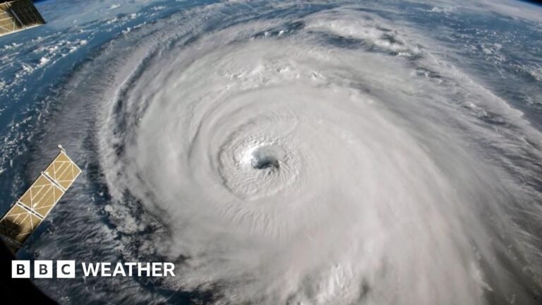 photo of a swirl of white, with an eye in the middle, showing hurricane Florence from space